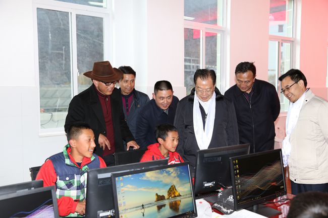 10、張學(xué)武董事長一行在集團捐助的德欽縣“希望之星”電腦室考察，并饒有興致地教授學(xué)生使用搜索引擎_副本.jpg